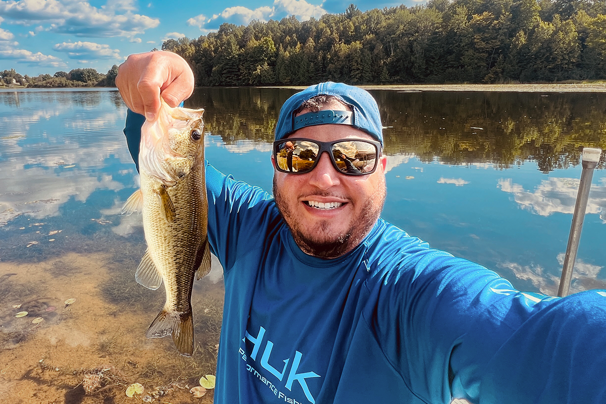 Snowboarder carving through powder in snowy terrain.