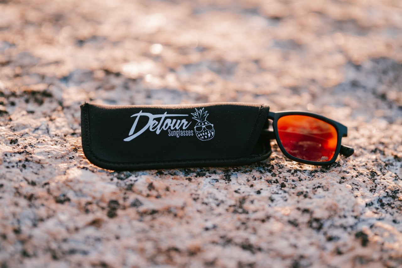 Snowboarder carving through powder in snowy terrain.