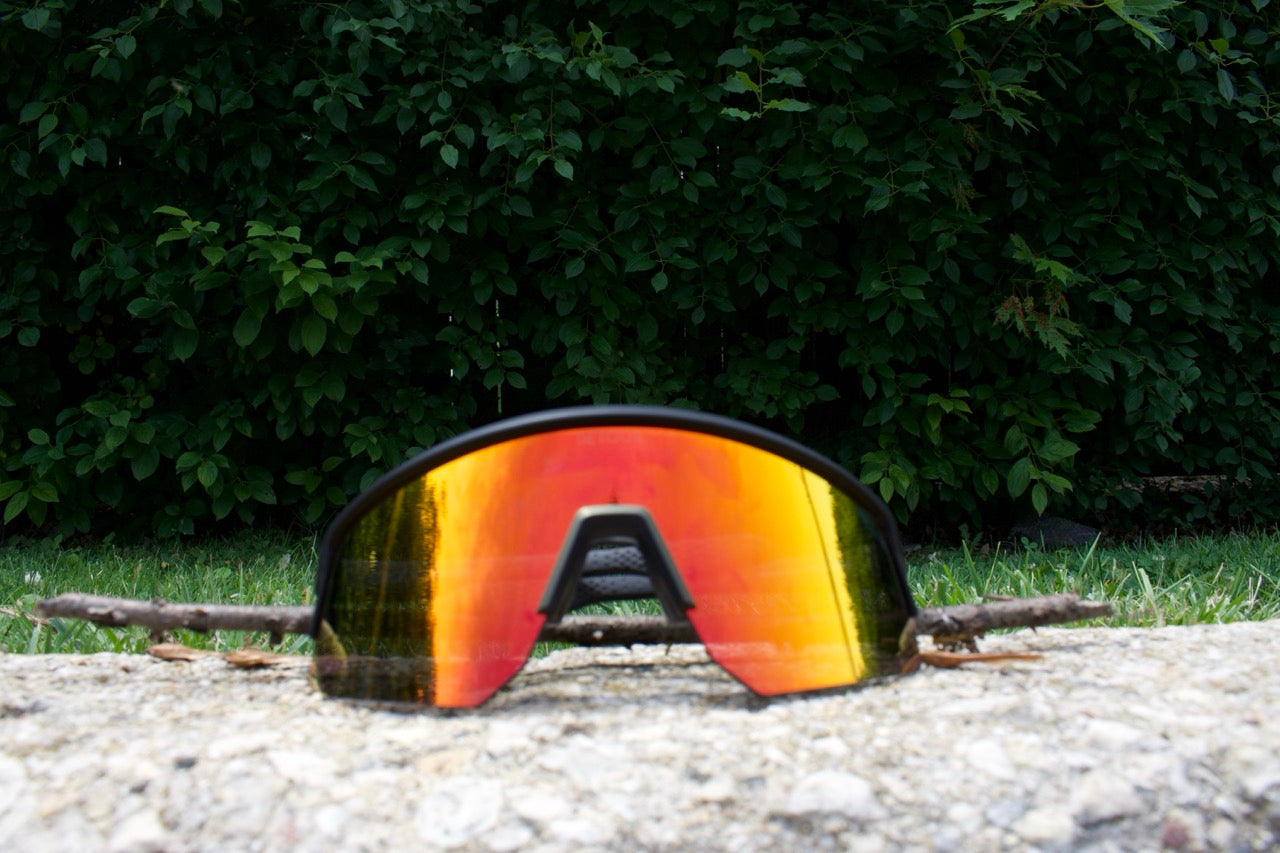 Snowboarder carving through powder in snowy terrain.