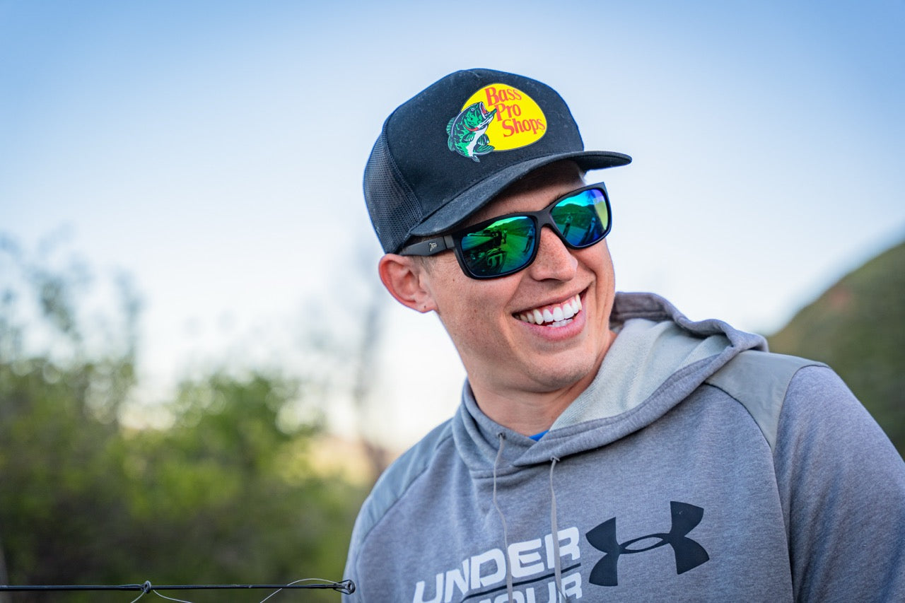 Snowboarder carving through powder in snowy terrain.