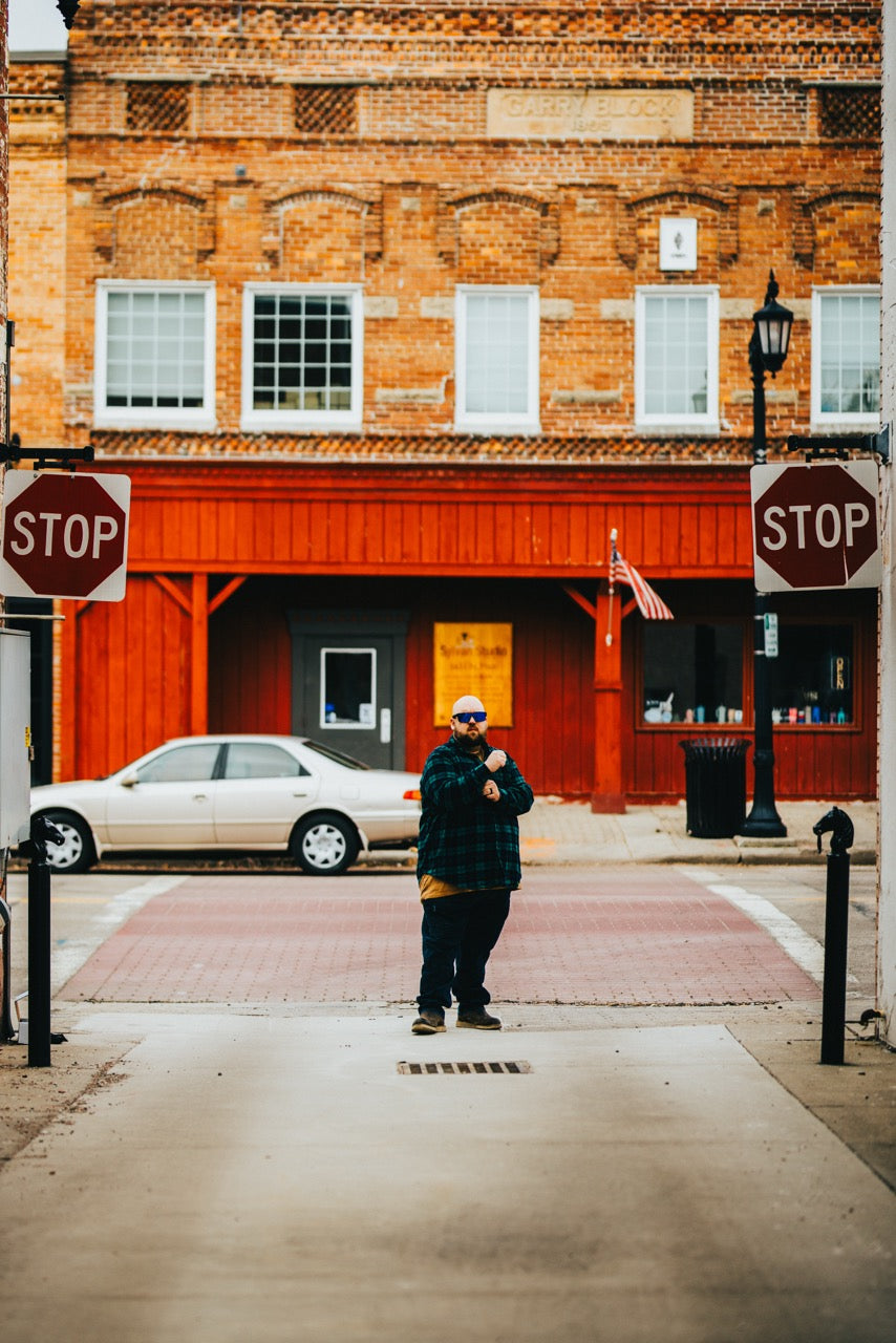 Snowboarder carving through powder in snowy terrain.