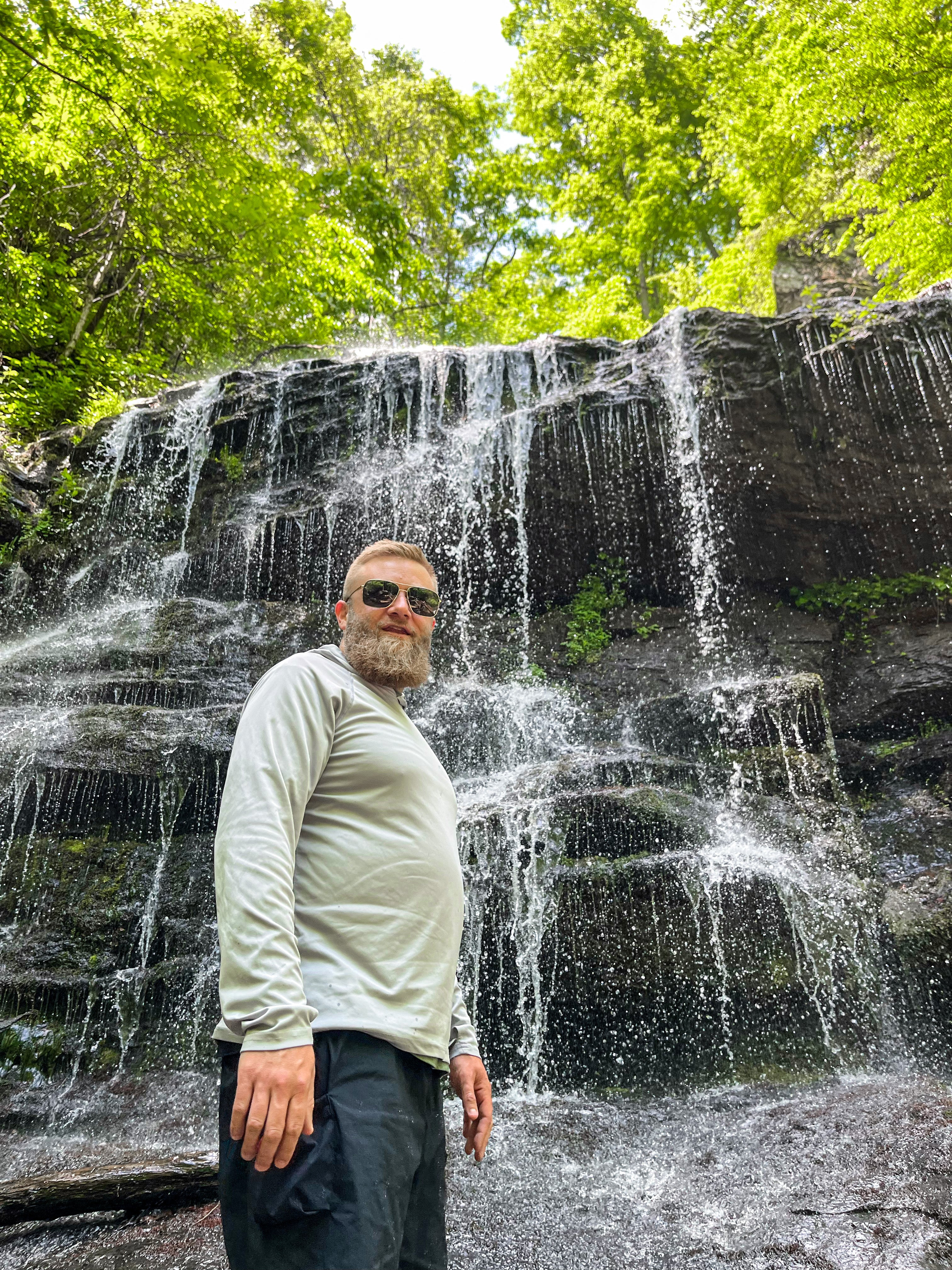 Snowboarder carving through powder in snowy terrain.