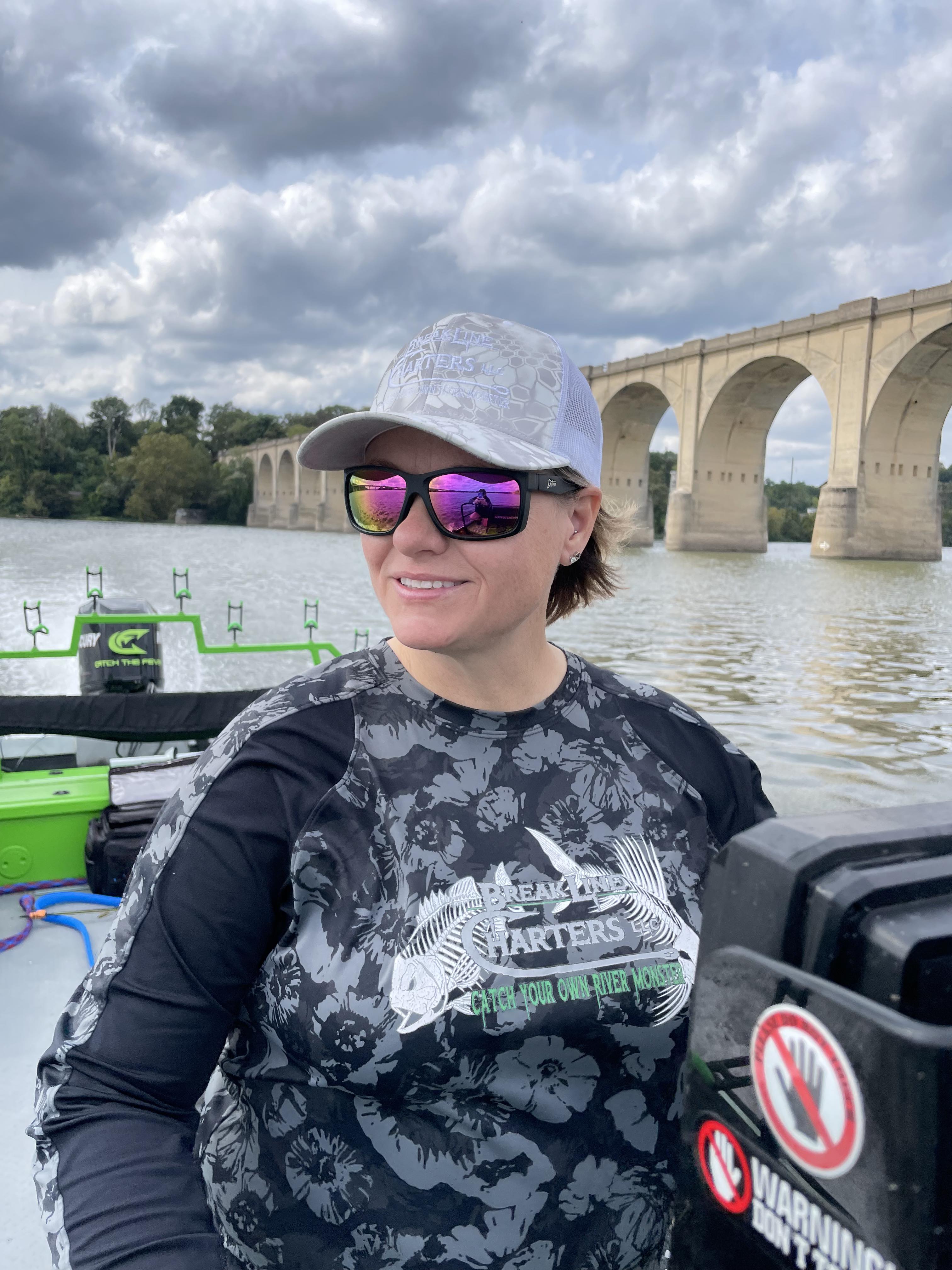 Man wearing mirrored goggles and gray beanie, holding skis in a snowy setting.