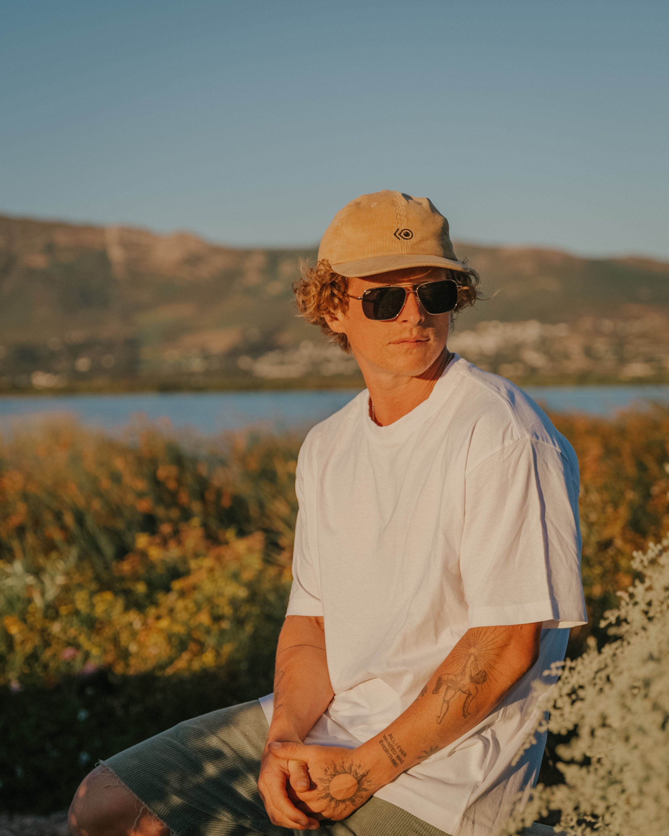 Snowboarder carving through powder in snowy terrain.