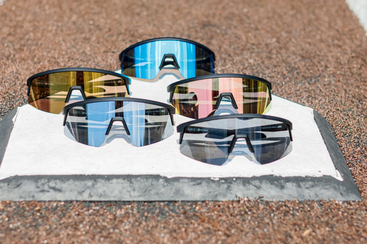 Snowboarder carving through powder in snowy terrain.