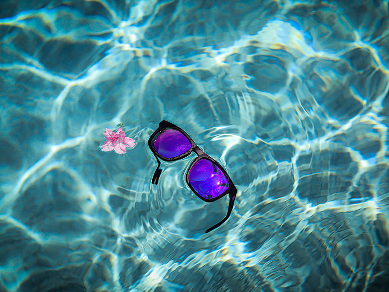 Snowboarder carving through powder in snowy terrain.