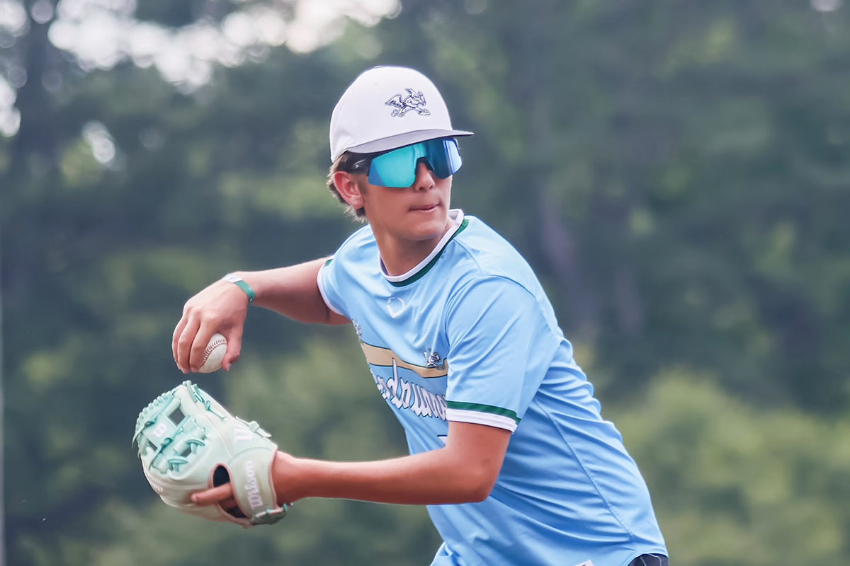Snowboarder carving through powder in snowy terrain.
