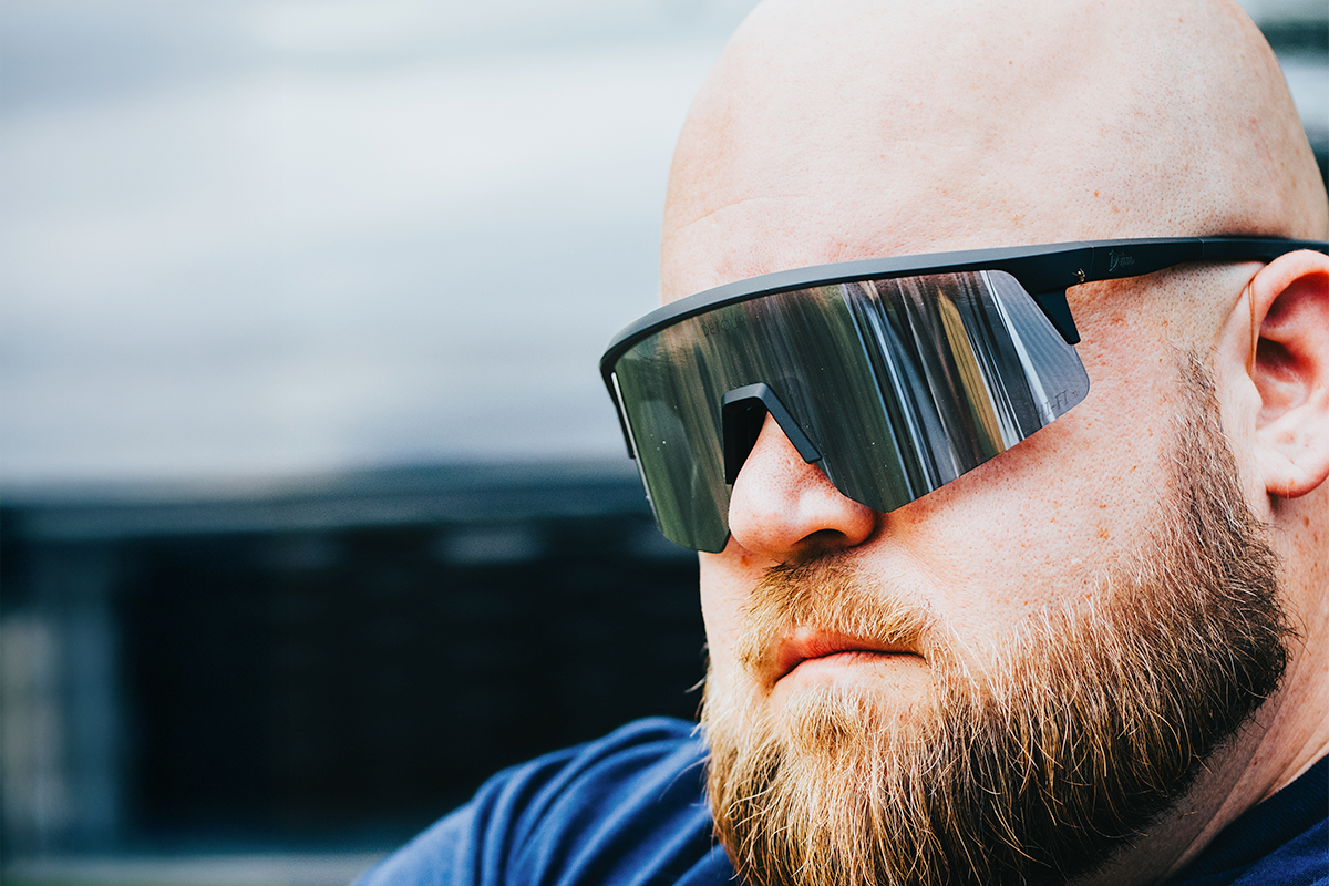 Snowboarder carving through powder in snowy terrain.